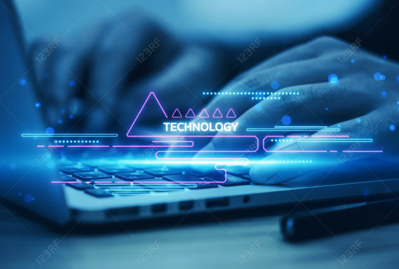 Hands typing on a laptop with a Technology holographic overlay